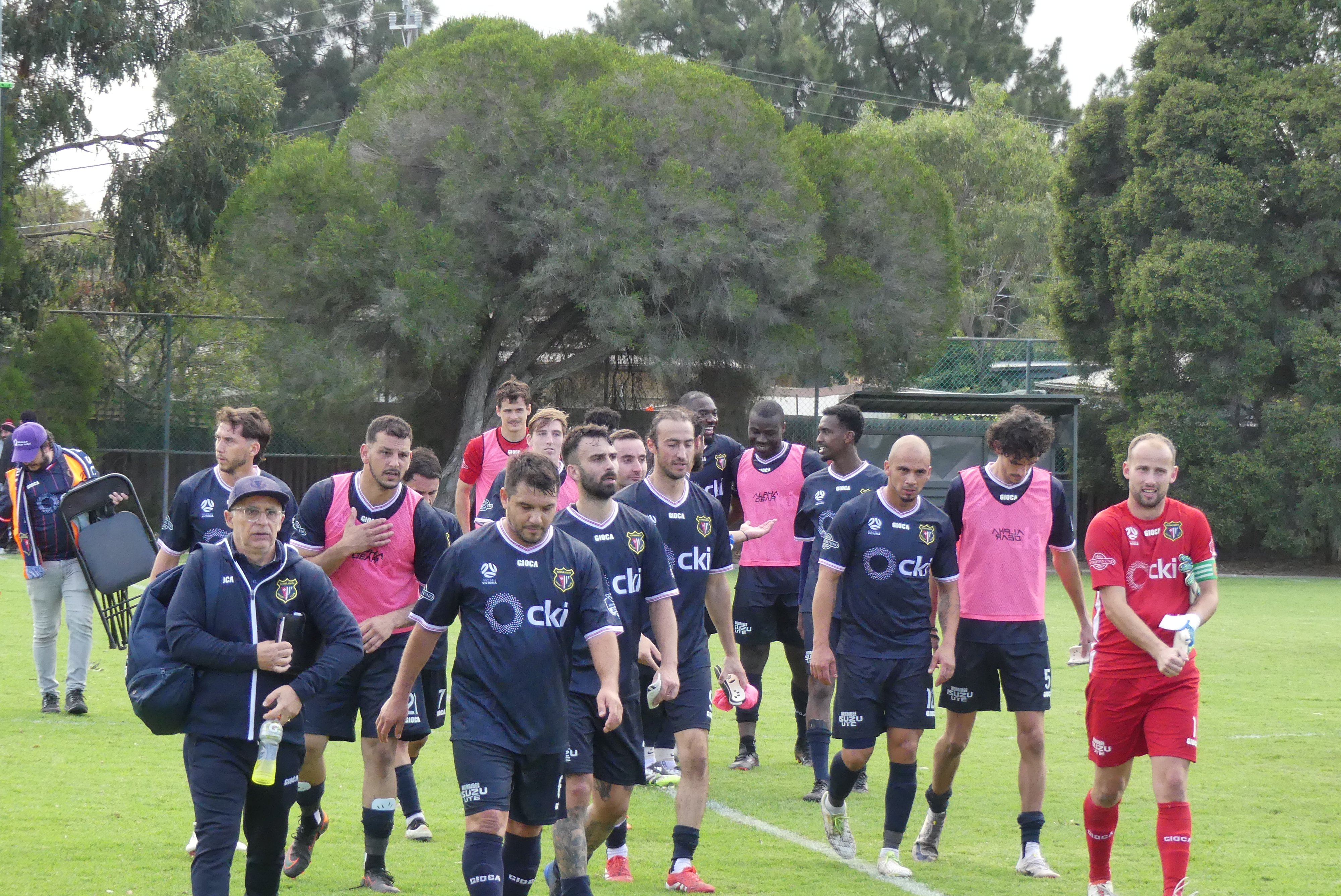 Altona North SC senior squad walking onto the pitch